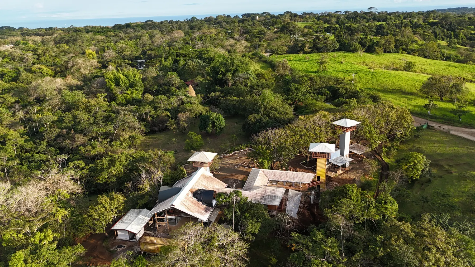 Drone photo of the Elevate construction site surrounded by forest and pasture at Rancho Delicioso